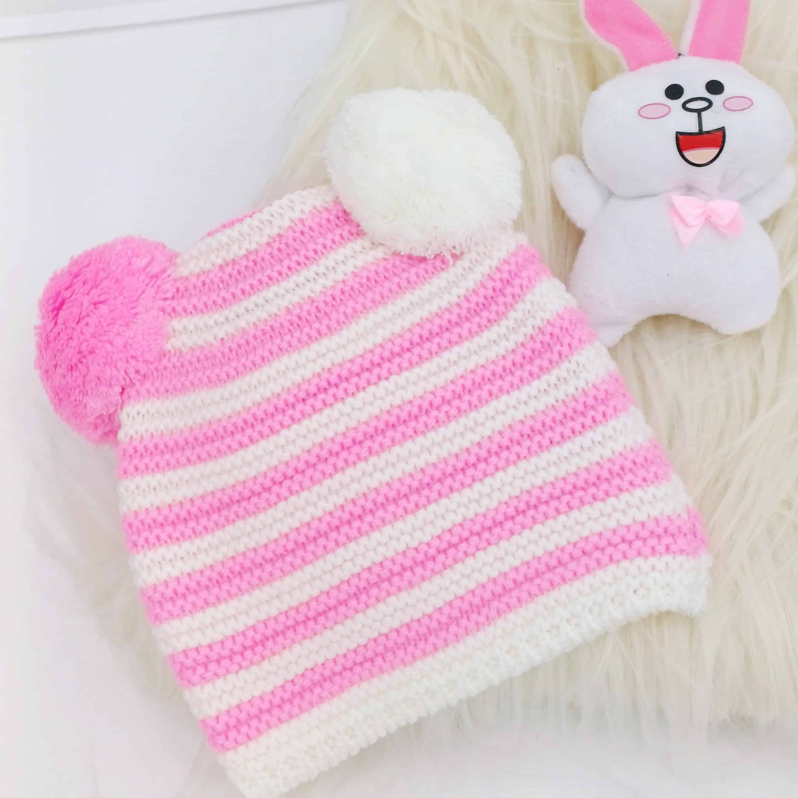 Découvrez nos bonnets en tricot rayé pour bébés avec pompons, disponibles en plusieurs couleurs. Doux, extensibles et parfaits pour les enfants de 0 à 2 ans.